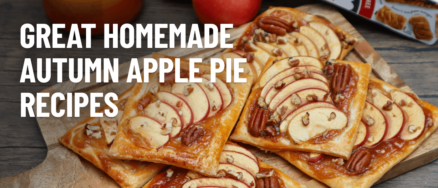 A wooden cutting board displaying fresh caramel, apple and pecan pastry slices